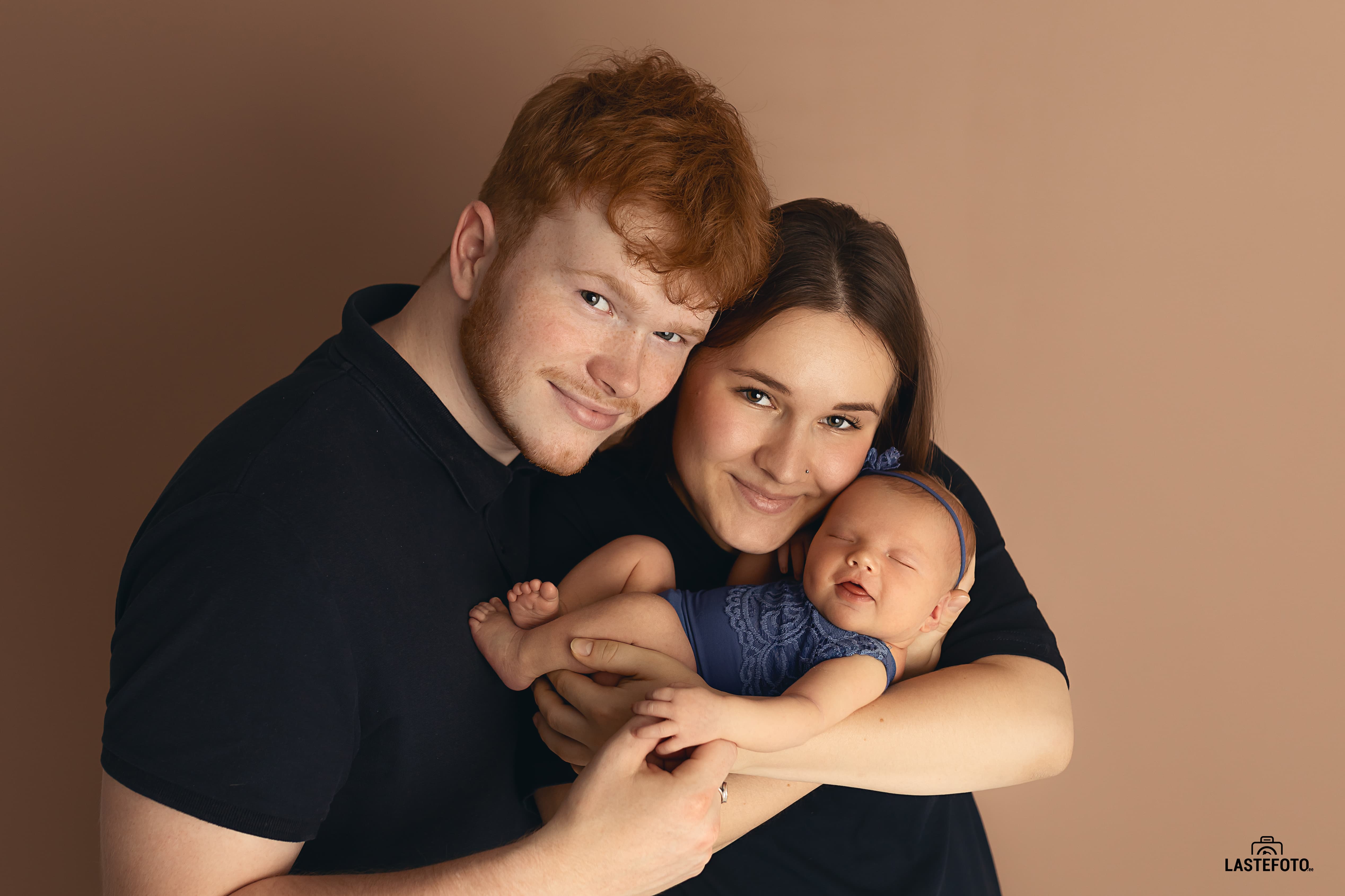 Smiling newborn baby with parents