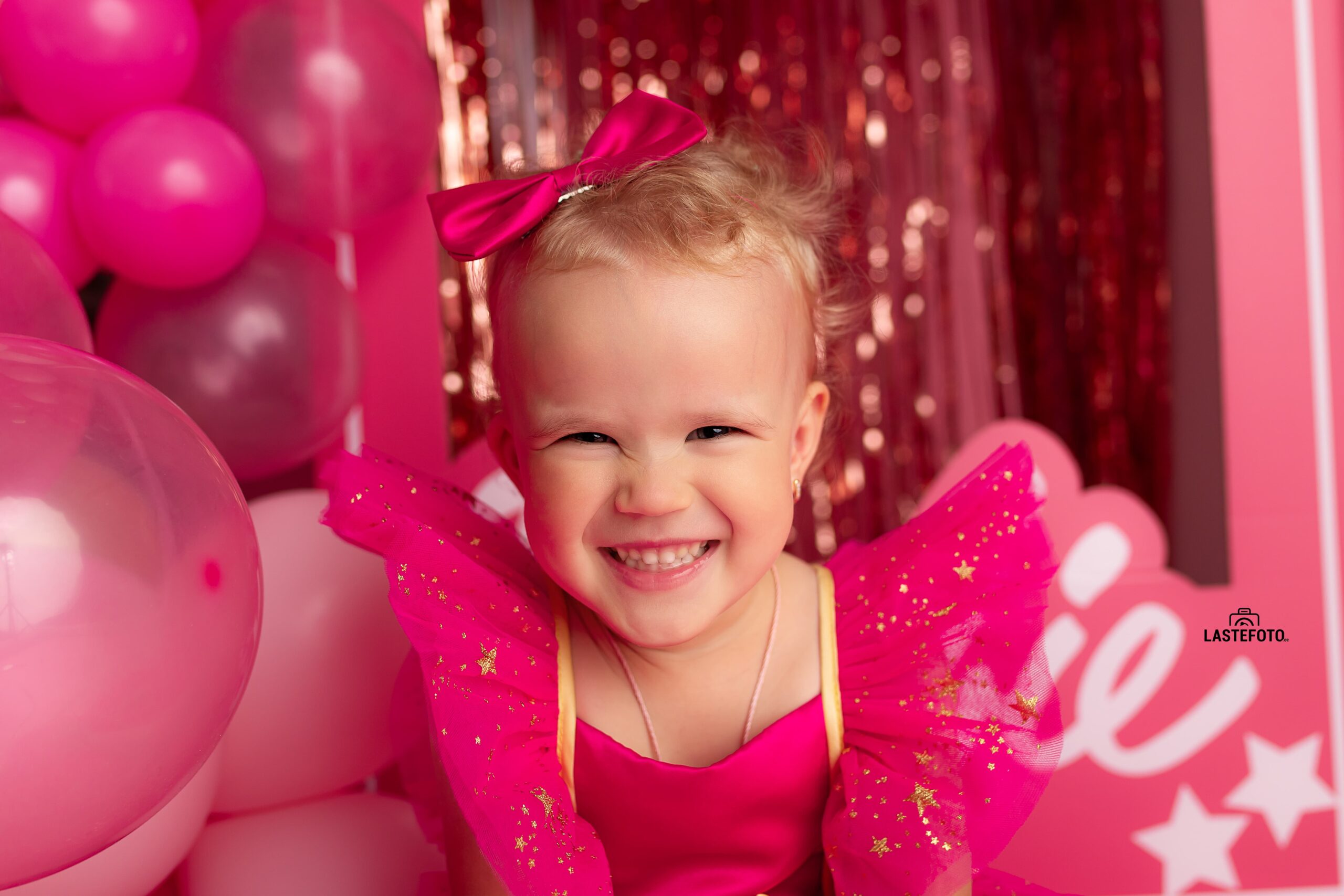Barbie photoshoot: A pink dream come true 1 Smiling girl in a pink dress during a Barbie photoshoot