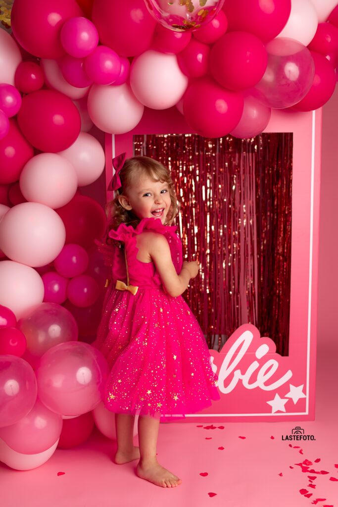 Barbie photoshoot: A pink dream come true 2 Smiling girl in a pink dress during a Barbie photoshoot surrounded by balloons