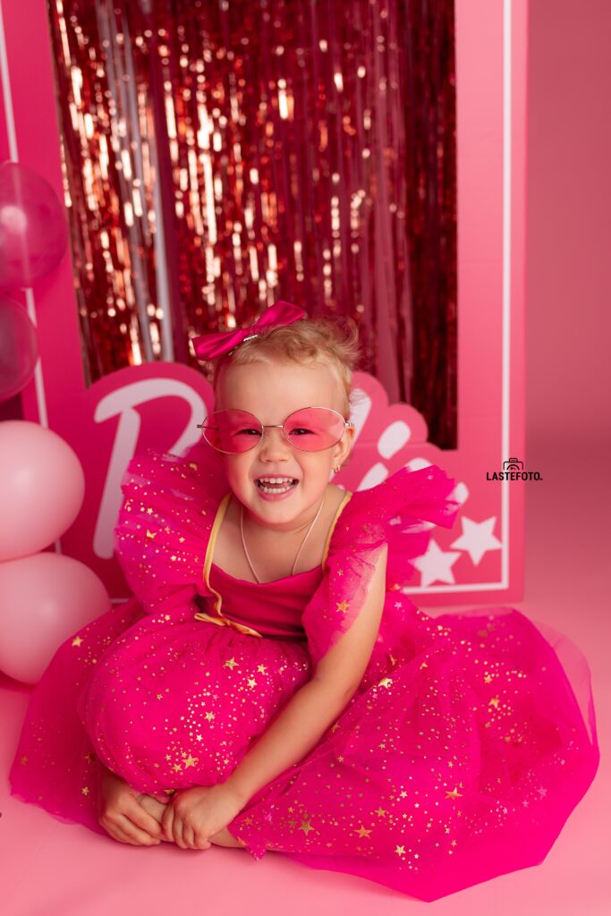 Barbie photoshoot: A pink dream come true 3 Smiling girl in pink sunglasses and sparkly dress during a Barbie photoshoot