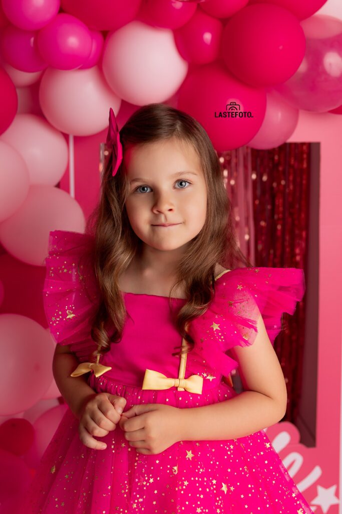 Barbie photoshoot: A pink dream come true 4 Serious-looking girl in a pink dress during a Barbie photoshoot with balloons