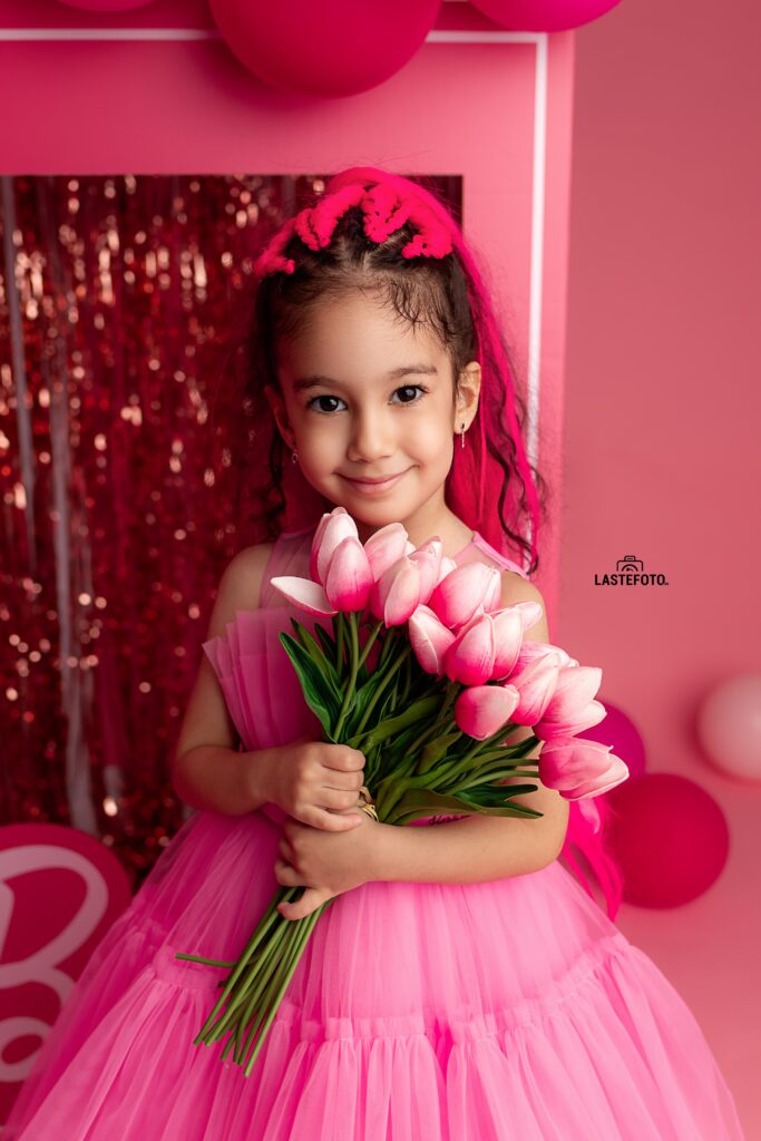 Barbie photoshoot: A pink dream come true 5 Girl in a pink dress holding a bouquet of pink tulips during a Barbie photoshoot