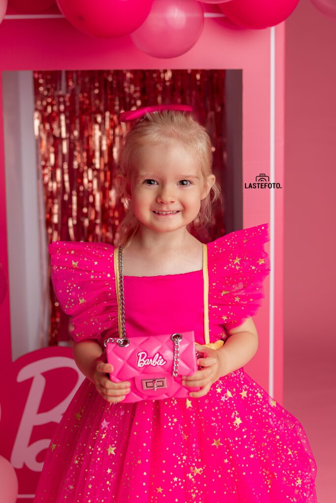 Barbie photoshoot: A pink dream come true 7 Girl in a pink dress holding a Barbie handbag during a Barbie photoshoot