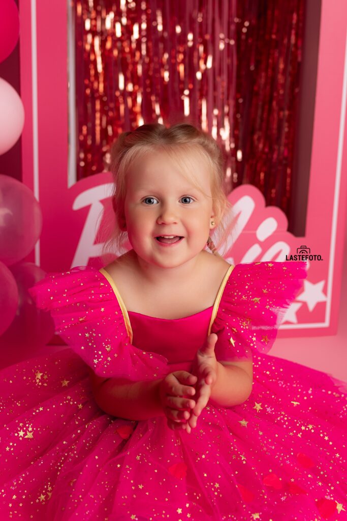 Barbie photoshoot: A pink dream come true 8 Little girl clapping in a sparkly pink dress during a Barbie photoshoot