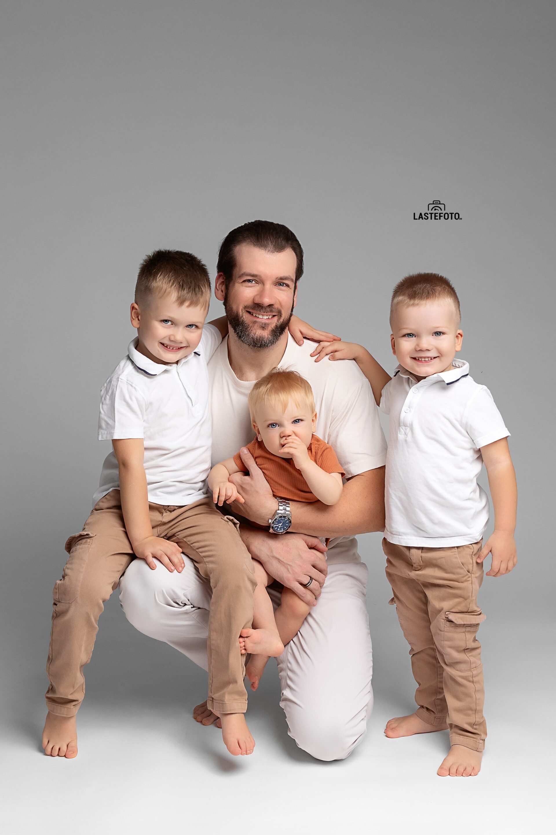 Fashion Photo Shoot 6 Fashion photoshoot – father with three sons in coordinated beige and white outfits.
