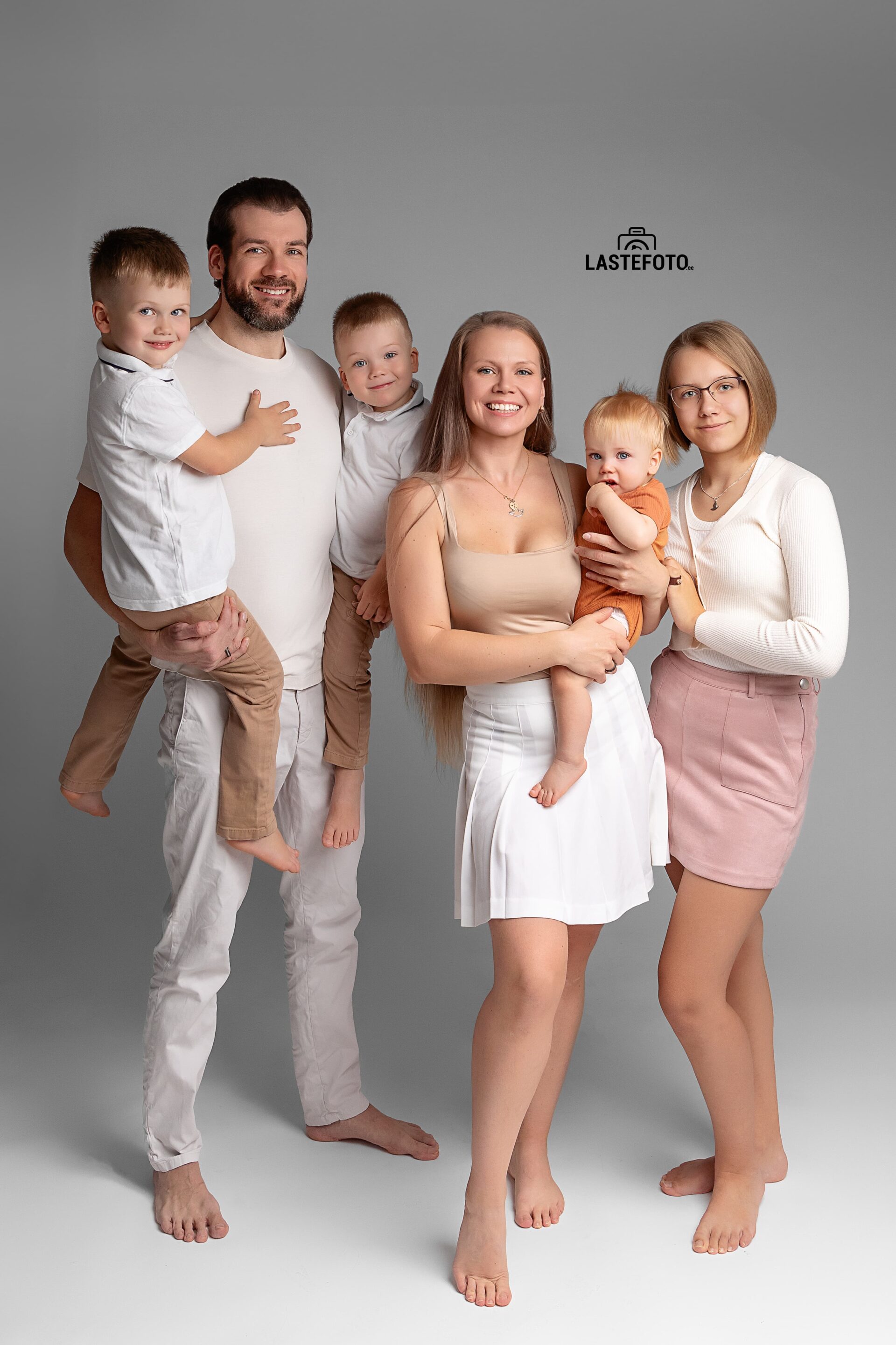 Fashion Photo Shoot 4 Fashion photoshoot with six family members on a white studio background, dressed in coordinated outfits.