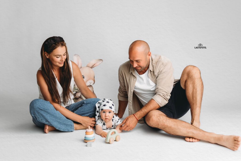 Best Age for Baby Photos: What to Expect at 4, 6, 9 and 11 Months 13 baby lying on their tummy between mum and dad and playing with wooden toys